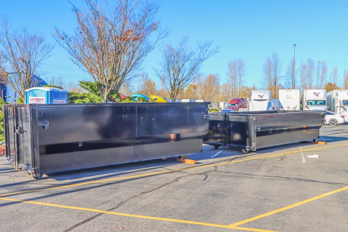 Professional dumpster rental service with roll-off container on residential driveway in Lakeland